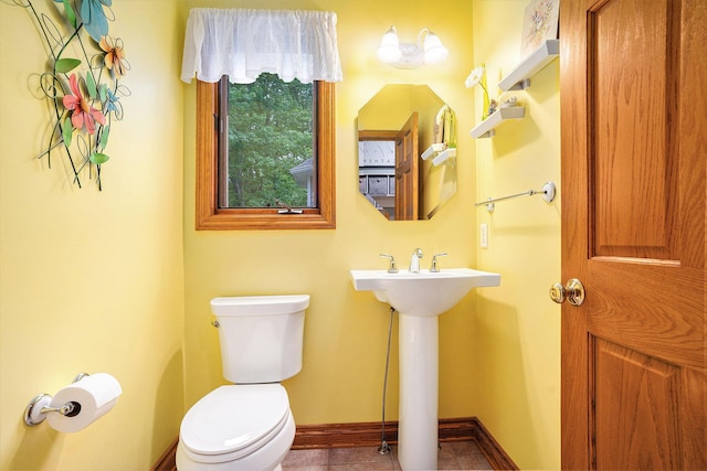 8837 56th Ave, Hudsonville, MI 49426 - half bath with toilet, baseboards, a sink, and tile patterned floors