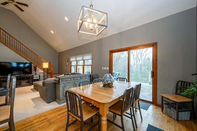 4569 Terra Ln, Saint Joseph, MI 49085 - dining area featuring lofted ceiling, light wood-style floors, stairs, a chandelier, and recessed lighting