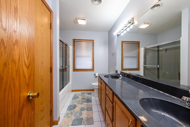 4569 Terra Ln, Saint Joseph, MI 49085 - bathroom with double vanity, tile patterned floors, and shower / bath combination with glass door