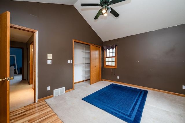 4569 Terra Ln, Saint Joseph, MI 49085 - unfurnished bedroom featuring high vaulted ceiling, a closet, light colored carpet, and a ceiling fan