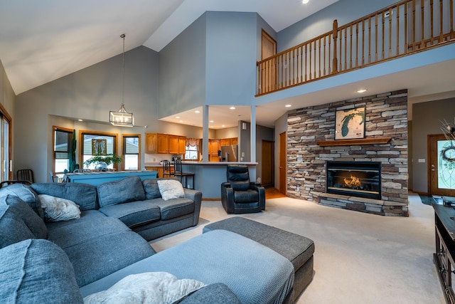 4569 Terra Ln, Saint Joseph, MI 49085 - living room featuring high vaulted ceiling, light carpet, and a stone fireplace