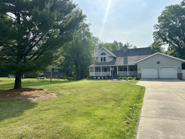 4569 Terra Ln, Saint Joseph, MI 49085 - view of front facade with covered porch, a garage, driveway, a front yard, and a chimney