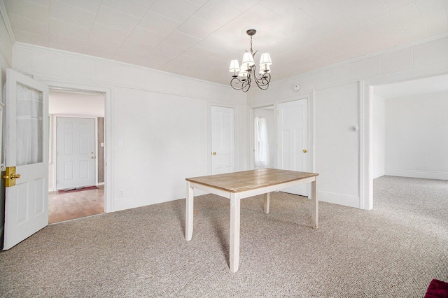 501 E Paw Paw St, Paw Paw, MI 49079 - unfurnished dining area with carpet floors, crown molding, and a chandelier