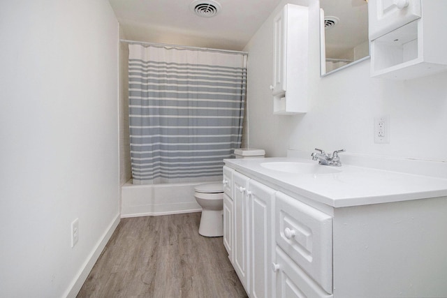 501 E Paw Paw St, Paw Paw, MI 49079 - bathroom with vanity, toilet, wood finished floors, and shower / tub combo with curtain