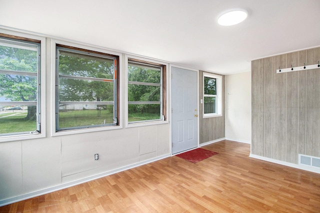 501 E Paw Paw St, Paw Paw, MI 49079 - foyer featuring light wood finished floors, healthy amount of natural light, and baseboards