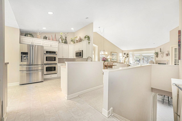 159 Water Lily Way NE, Comstock Park, MI 49321 - kitchen with stainless steel appliances, baseboards, open floor plan, lofted ceiling, and light countertops