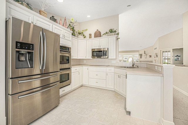 159 Water Lily Way NE, Comstock Park, MI 49321 - kitchen with appliances with stainless steel finishes, a peninsula, a sink, tasteful backsplash, and light countertops