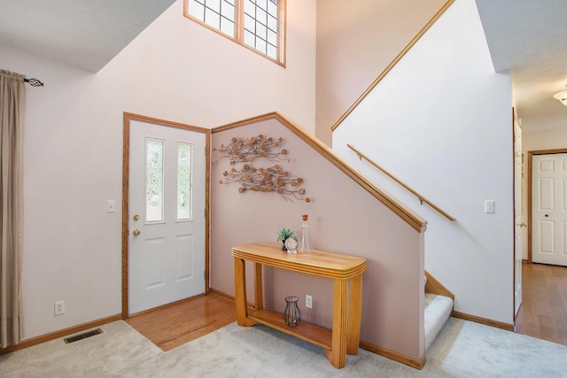2481 Jameswood Ct, Holland, MI 49424 - carpeted entrance foyer featuring stairway and baseboards