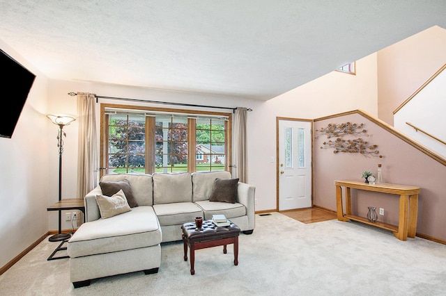 2481 Jameswood Ct, Holland, MI 49424 - living area with baseboards, carpet floors, stairs, and lofted ceiling