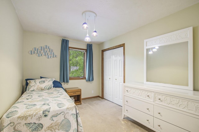 2481 Jameswood Ct, Holland, MI 49424 - bedroom with light carpet, baseboards, and a closet