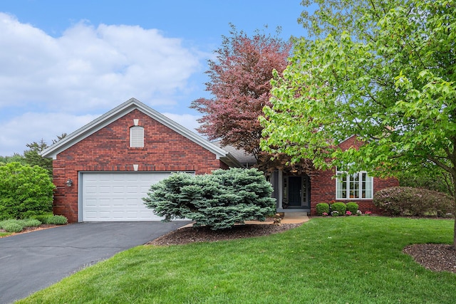 2176 Teal Ct SE, Grand Rapids, MI 49546 - obstructed view of property with driveway, a front yard, and brick siding