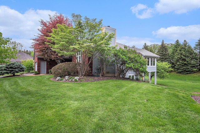 2176 Teal Ct SE, Grand Rapids, MI 49546 - view of front facade featuring a front yard and a chimney