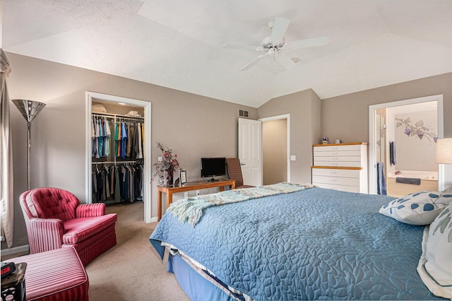 2176 Teal Ct SE, Grand Rapids, MI 49546 - carpeted bedroom with a walk in closet, vaulted ceiling, a closet, a ceiling fan, and ensuite bathroom
