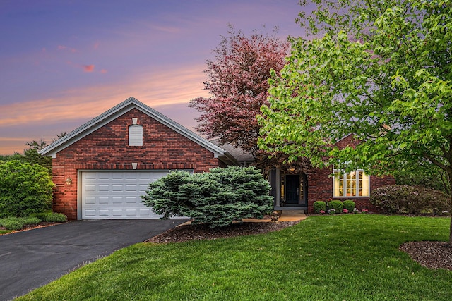 2176 Teal Ct SE, Grand Rapids, MI 49546 - view of front facade featuring asphalt driveway, a front yard, brick siding, and an attached garage