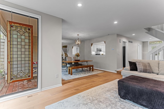 2485 Wildbrook Run Unit 154, Bloomfield Hills, MI 48304 - living area with wood finished floors, baseboards, stairway, a chandelier, and recessed lighting