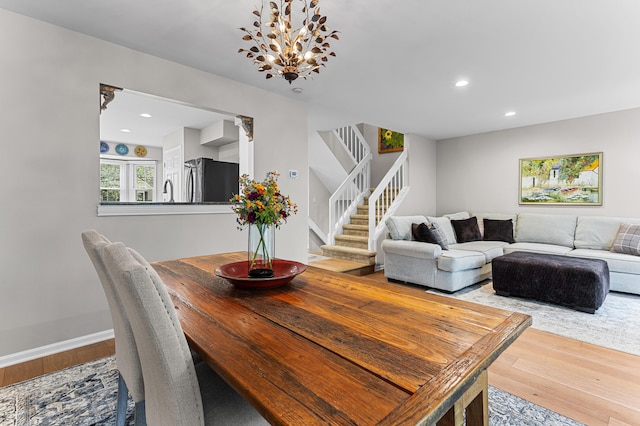 2485 Wildbrook Run Unit 154, Bloomfield Hills, MI 48304 - dining room featuring wood-type flooring, stairs, recessed lighting, baseboards, and a chandelier