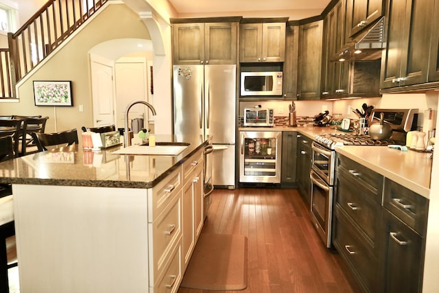 300 Morning Walk Path, Benton Harbor, MI 49022 - kitchen featuring wine cooler, appliances with stainless steel finishes, a sink, under cabinet range hood, and dark wood finished floors