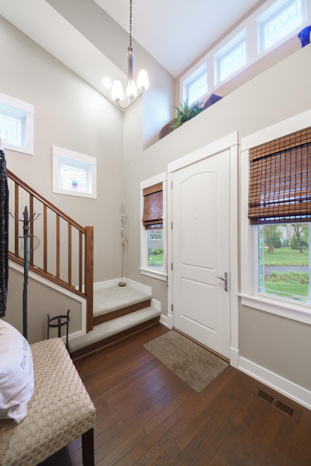 300 Morning Walk Path, Benton Harbor, MI 49022 - foyer featuring baseboards, hardwood / wood-style flooring, high vaulted ceiling, a chandelier, and stairs