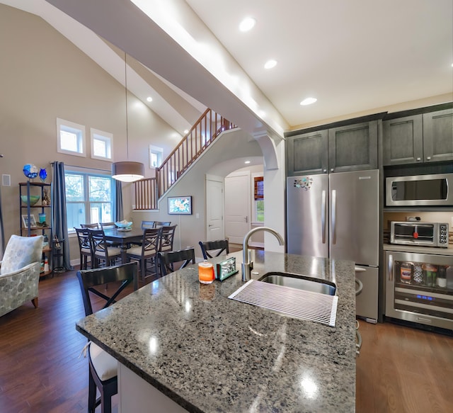 300 Morning Walk Path, Benton Harbor, MI 49022 - kitchen featuring stainless steel appliances, a sink, a center island with sink, dark wood-type flooring, and light stone countertops