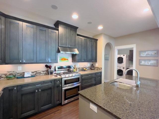 300 Morning Walk Path, Benton Harbor, MI 49022 - kitchen featuring double oven range, estacked washer and dryer, a sink, under cabinet range hood, and dark wood-type flooring