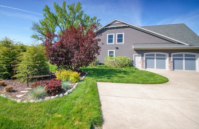 300 Morning Walk Path, Benton Harbor, MI 49022 - view of property exterior with concrete driveway, an attached garage, a lawn, and a shingled roof