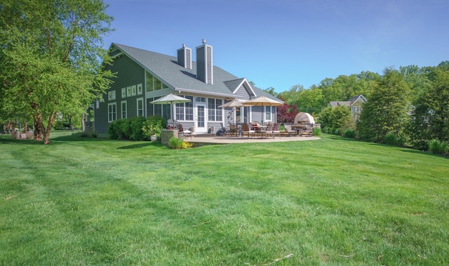 300 Morning Walk Path, Benton Harbor, MI 49022 - rear view of property featuring a patio area, a lawn, and a chimney