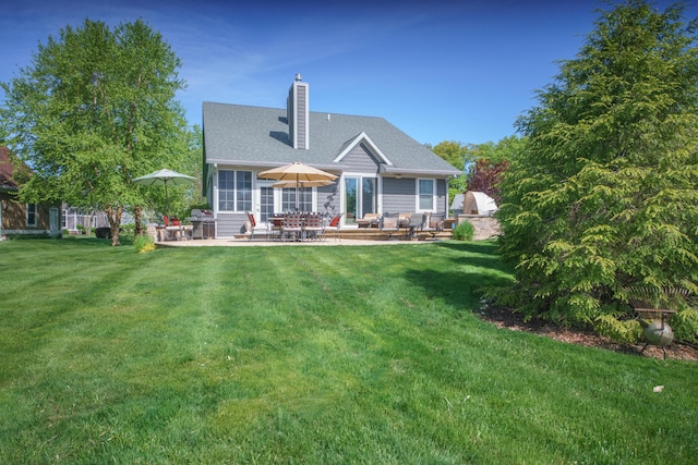 300 Morning Walk Path, Benton Harbor, MI 49022 - back of property featuring a patio area, a chimney, a yard, and a shingled roof
