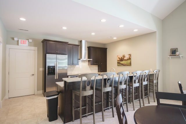 300 Morning Walk Path, Benton Harbor, MI 49022 - kitchen with stainless steel refrigerator with ice dispenser, wall chimney exhaust hood, a breakfast bar area, decorative backsplash, and light countertops