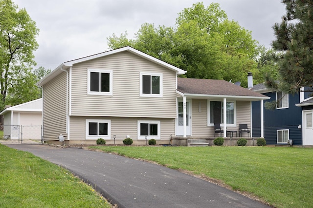 692 Woodingham Ave, Waterford, MI 48328 - tri-level home with a gate, a front lawn, covered porch, and a garage