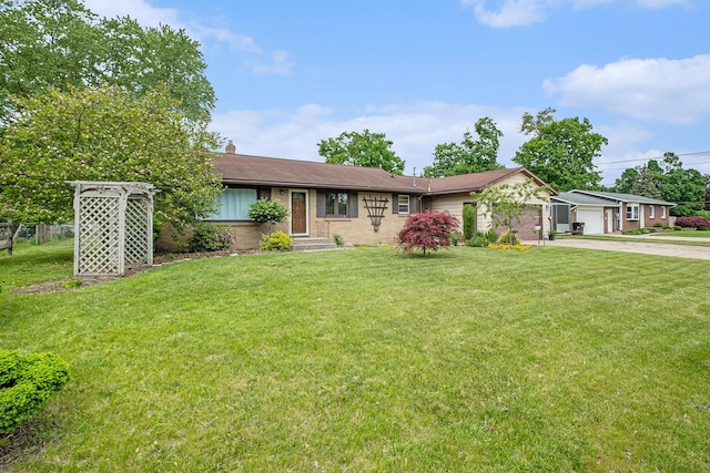7569 Astronaut Ave, Jenison, MI 49428 - ranch-style home featuring driveway, a front yard, a garage, and brick siding