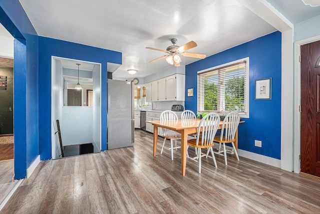 7569 Astronaut Ave, Jenison, MI 49428 - dining room featuring a ceiling fan, wood finished floors, and baseboards