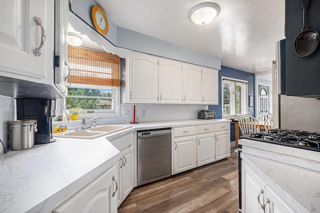 7569 Astronaut Ave, Jenison, MI 49428 - kitchen with stainless steel dishwasher, a sink, healthy amount of natural light, and white cabinetry