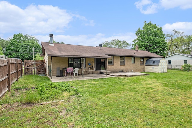 7569 Astronaut Ave, Jenison, MI 49428 - back of property with a patio, a chimney, brick siding, and a shingled roof