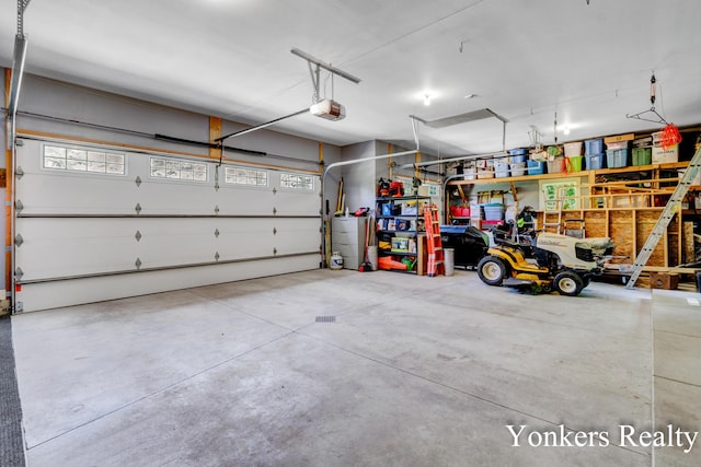 1109 Kenowa Ave SW, Byron Center, MI 49315 - garage featuring a garage door opener and water heater