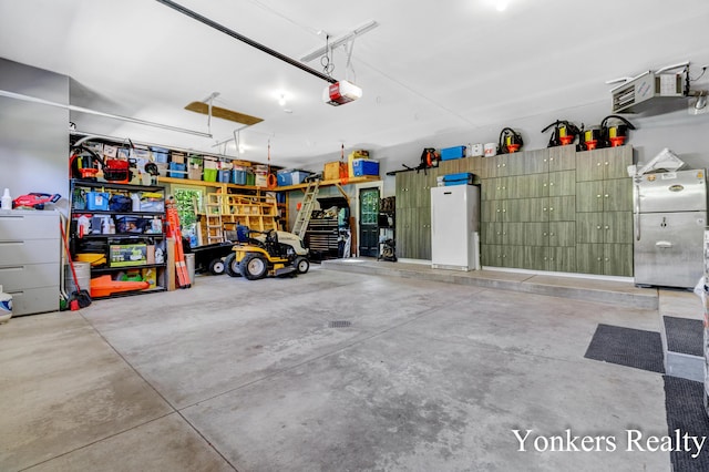 1109 Kenowa Ave SW, Byron Center, MI 49315 - garage featuring freestanding refrigerator and a garage door opener