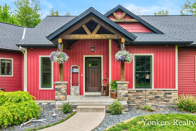 1109 Kenowa Ave SW, Byron Center, MI 49315 - entrance to property with a shingled roof and stone siding