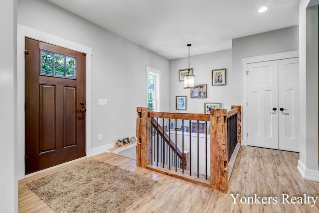 1109 Kenowa Ave SW, Byron Center, MI 49315 - foyer entrance featuring healthy amount of natural light, wood finished floors, baseboards, a chandelier, and recessed lighting