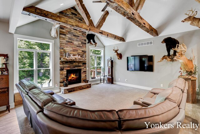 1109 Kenowa Ave SW, Byron Center, MI 49315 - living area with high vaulted ceiling, baseboards, beam ceiling, a fireplace, and carpet