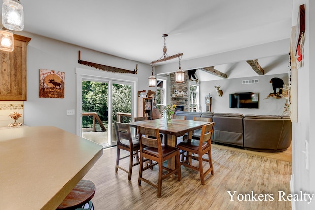 1109 Kenowa Ave SW, Byron Center, MI 49315 - dining room with a fireplace and light wood-style floors