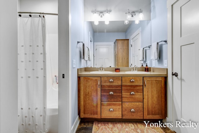 1109 Kenowa Ave SW, Byron Center, MI 49315 - bathroom featuring double vanity, a shower with curtain, and baseboards