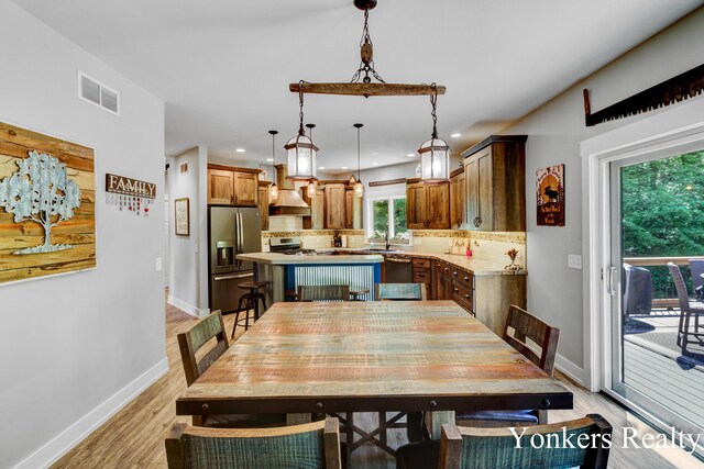 1109 Kenowa Ave SW, Byron Center, MI 49315 - dining area with baseboards, light wood-type flooring, and recessed lighting