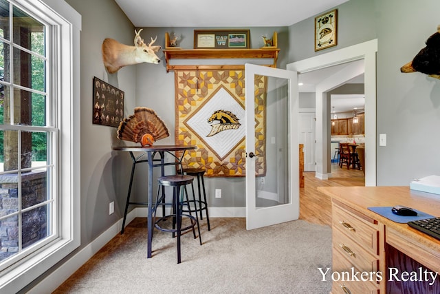 1109 Kenowa Ave SW, Byron Center, MI 49315 - dining room with french doors, carpet floors, baseboards, and an office area