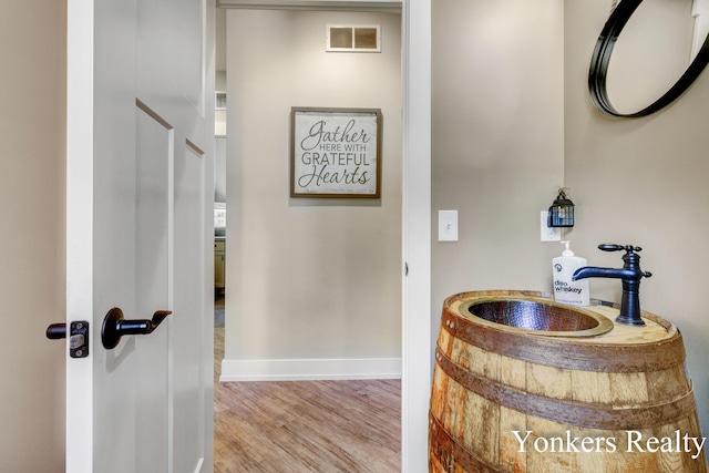 1109 Kenowa Ave SW, Byron Center, MI 49315 - bathroom with wood finished floors, baseboards, and a sink