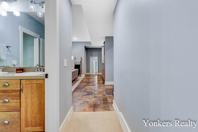 1109 Kenowa Ave SW, Byron Center, MI 49315 - corridor featuring baseboards and a sink