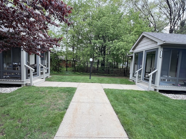 5764 W Brookwood Pl, Ludington, MI 49431 - view of green lawn with a sunroom