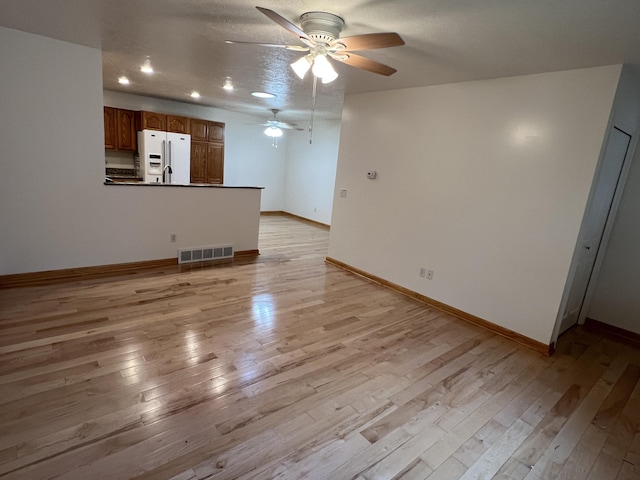 5764 W Brookwood Pl, Ludington, MI 49431 - unfurnished living room featuring a ceiling fan, light wood-style floors, baseboards, and recessed lighting