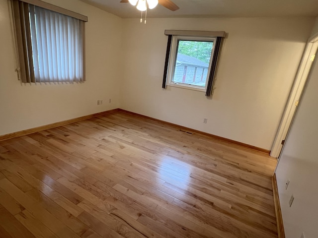 5764 W Brookwood Pl, Ludington, MI 49431 - empty room with wood-type flooring, ceiling fan, and baseboards