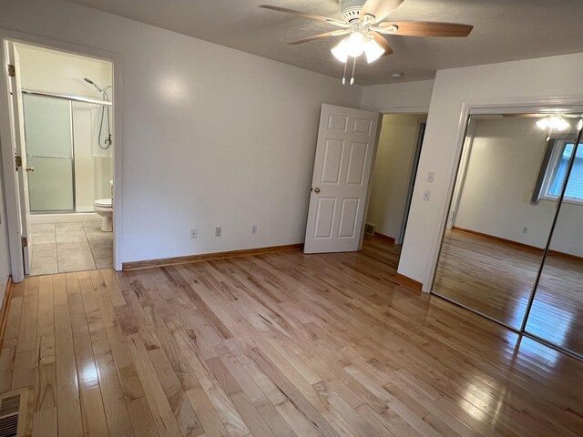 5764 W Brookwood Pl, Ludington, MI 49431 - unfurnished bedroom with light wood finished floors, baseboards, and a closet