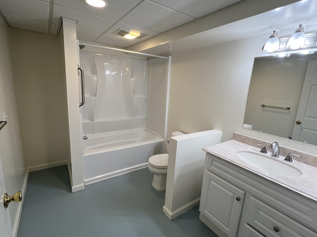 5764 W Brookwood Pl, Ludington, MI 49431 - bathroom with toilet, vanity, bathtub / shower combination, a paneled ceiling, and finished concrete flooring