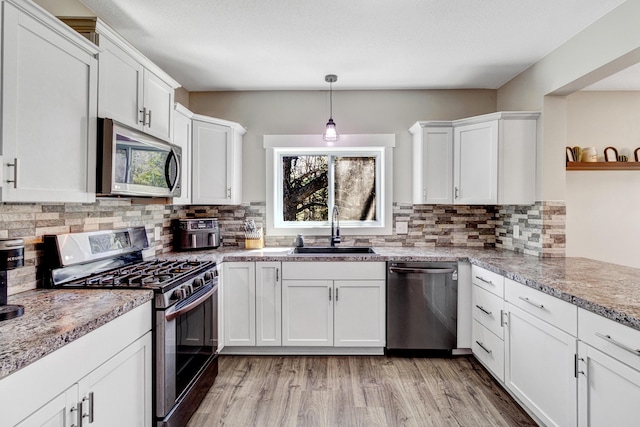 4371 N 68th Ave, Hart, MI 49420 - kitchen with appliances with stainless steel finishes, a sink, plenty of natural light, and white cabinetry